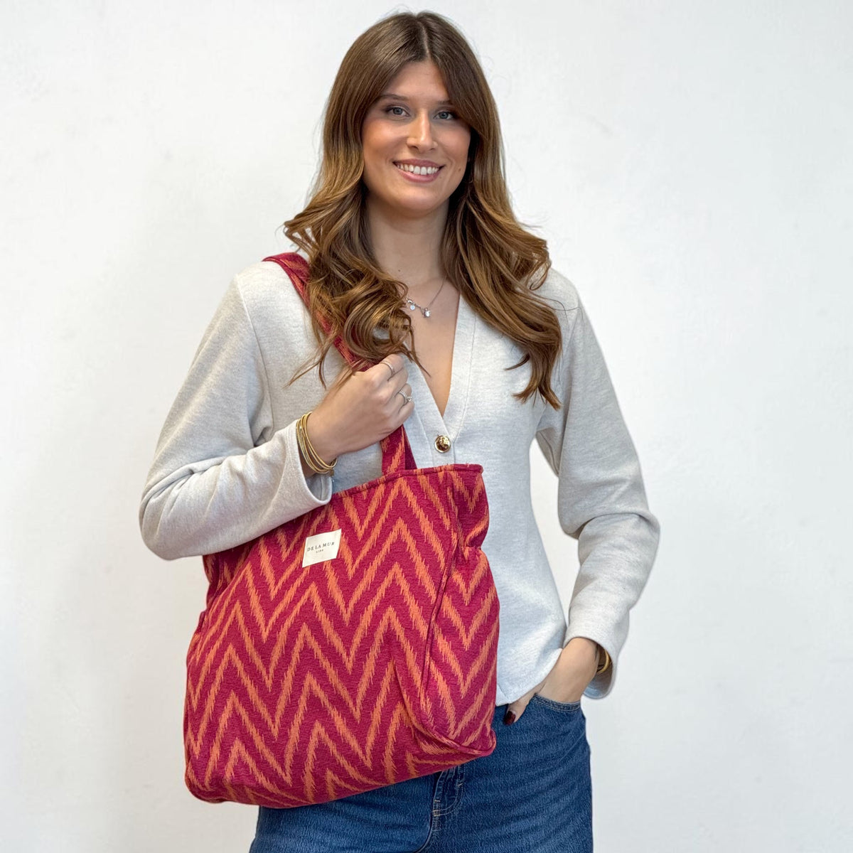 Bolsa con cremallera Fuego, estampado en rojo, naranja y amarillo, vista en uso — De La Mur