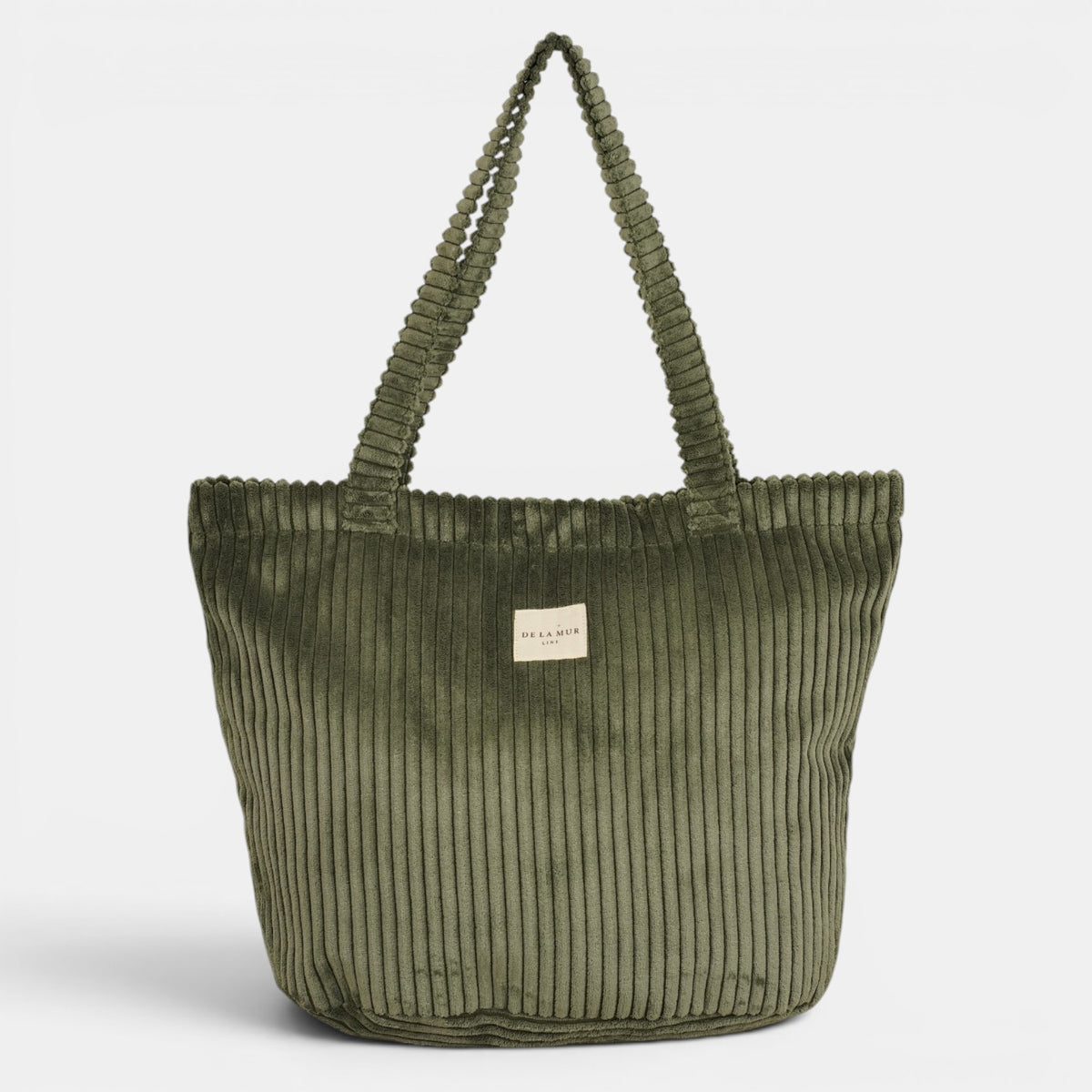 Bolsa grande con cremallera Musgo, acabado verde musgo, detalle del estampado y el material — De La Mur