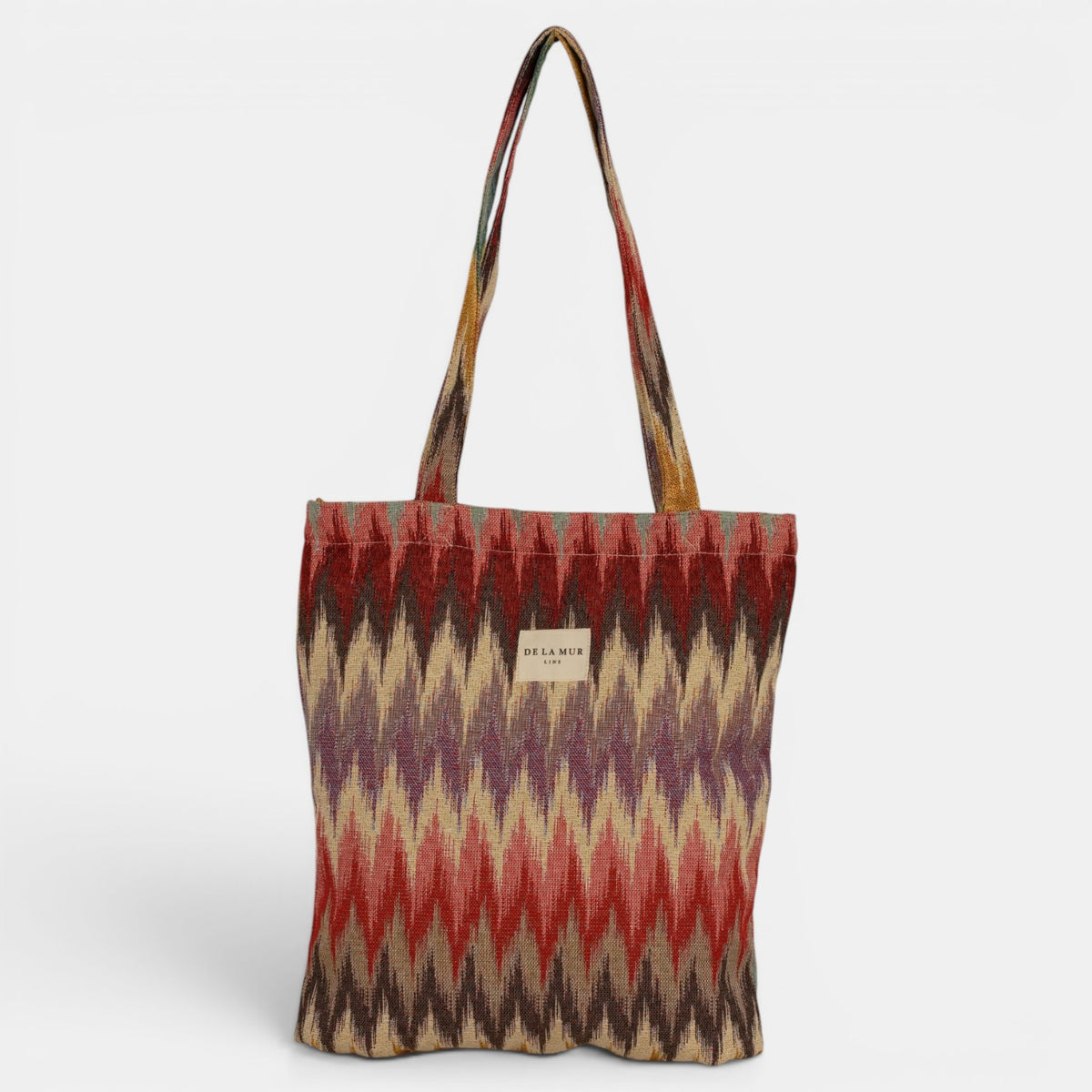 Bolsa pequeña Guana, estampado en blanco, beige, terracota, detalle del estampado y el material — De La Mur